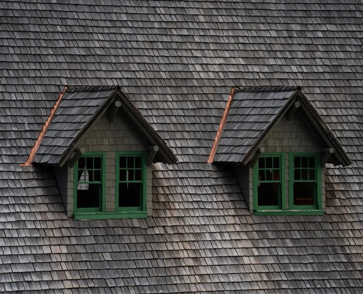 Dormers on a shingle roof in Spring Hill, FL, where step flashing and kickout flashing carry water past the walls